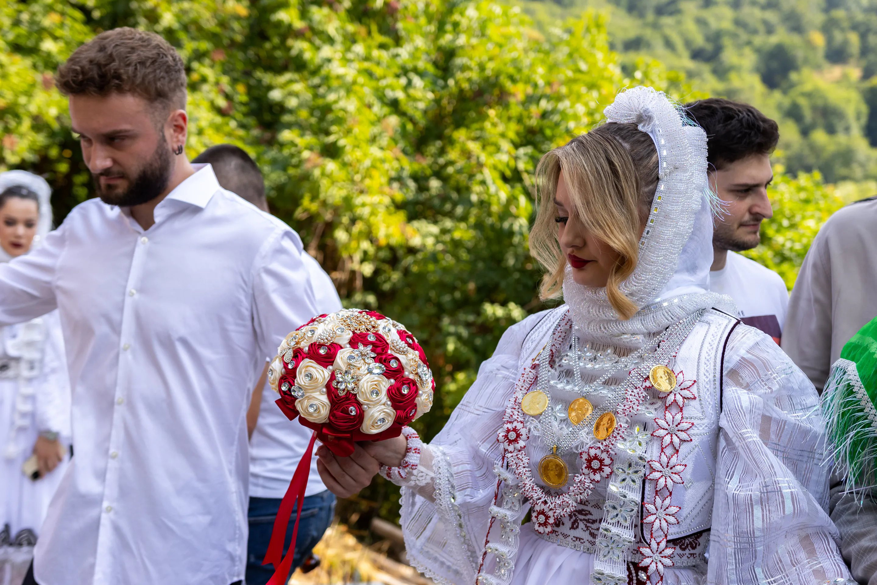 The brooch bouquet carried down the lane after the ceremony, the bride-to-be following in her beaded whites