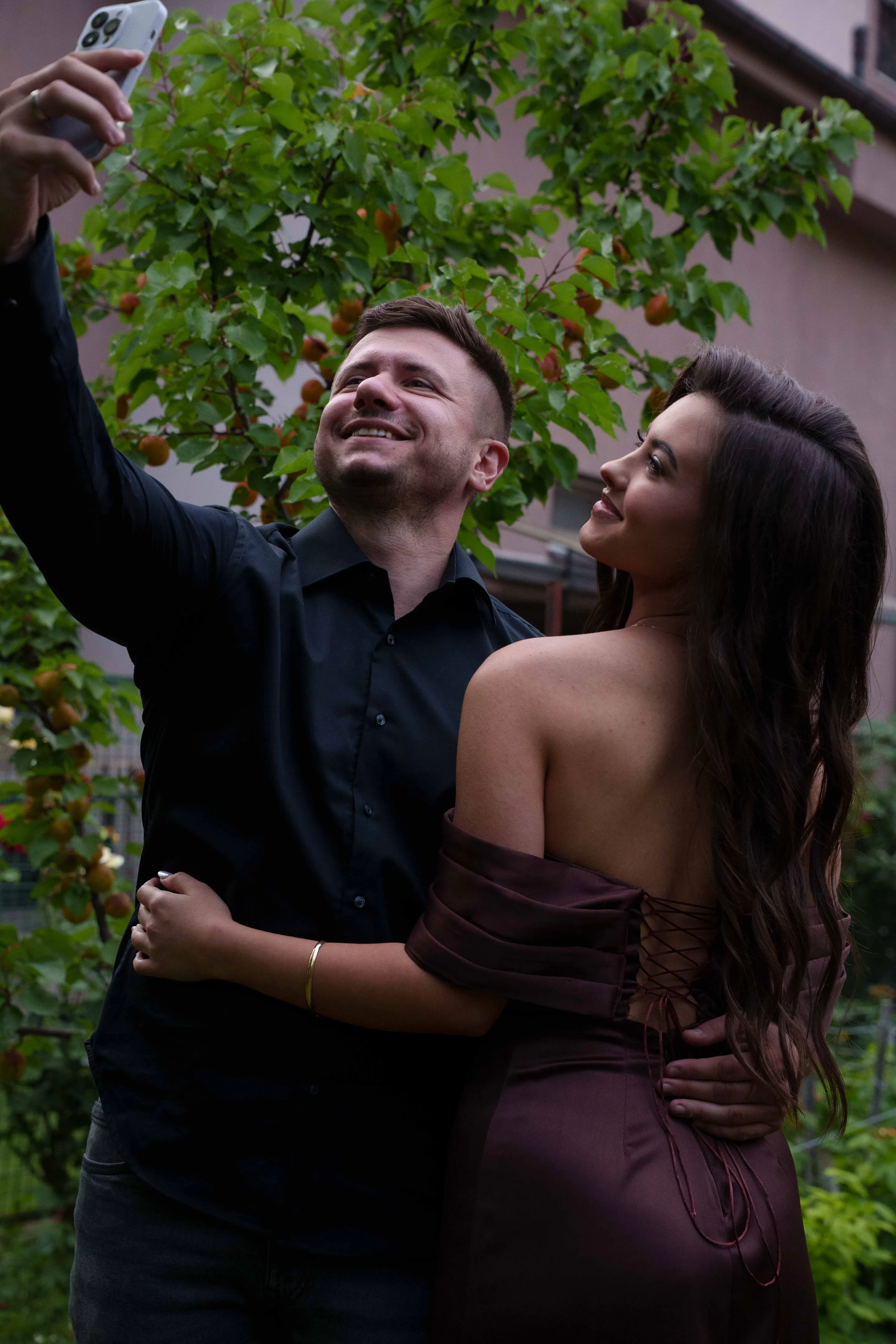 A selfie taken together beneath the climbing roses